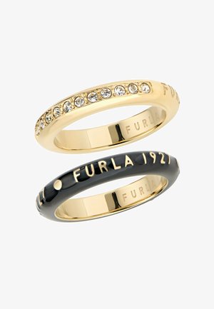 Two rings: one gold-tone with rhinestones, the other black with gold-tone lettering. Smooth surfaces with polished finishes.