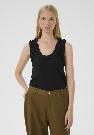 Black sleeveless top featuring a ruffled neckline, paired with brown high-waisted pants that have a front pocket and button detail.
