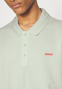 HUGO DONOS - Polo - light pastel green