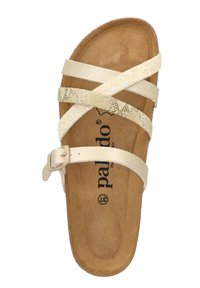 Sabot beige con cinturini incrociati in materiale sintetico, caratterizzato da un accento dorato luccicante. Soletta morbida e testurizzata con logo del marchio. Cinturino alla caviglia con fibbia.