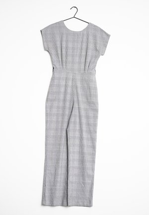 Gray plaid jumpsuit with short sleeves, wide legs, a fitted waist, and a round neckline. Hangs from a black hook against a white background.