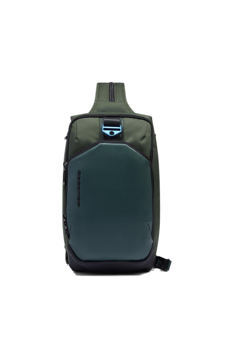Mochila verde con un exterior texturizado, un panel frontal verde oscuro elegante, detalles negros, una cremallera superior y un adorno azul metálico.