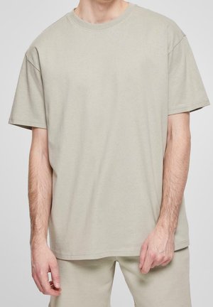 Lys grå, oversized bomulds T-shirt med rund hals og korte ærmer. Casual design med en glat tekstur og uden synlige mønstre eller detaljer.