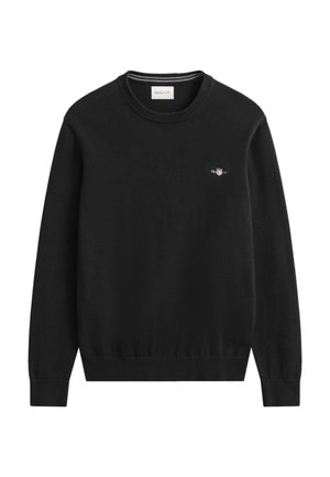 Schwarzer Strickpullover mit rundem Ausschnitt, gerippten Bündchen und Saum. Verfügt über ein kleines, gesticktes Logo auf der Brust.