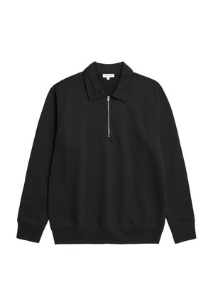Pull noir à manches longues avec col et fermeture éclair partielle à l’avant, poignets et bas côtelés.