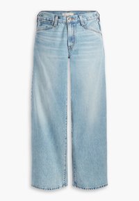 Ljusblå vida jeans med hög midja, gjorda av denim. Har en knappstängning, fem fickor och fransar i nederkant vid vristen.