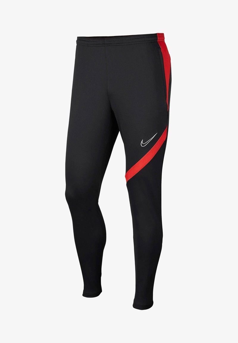 Leggings deportivos negros con un diseño ajustado, que presentan una franja lateral roja y un logo de Nike blanco en la parte frontal. Están fabricados con un tejido elástico.