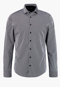 Musta-valkoinen kuvioitu paita, jossa on nappikaulus, pitkät hihat ja mustat napit. Kangas on teksturoitua geometrista kuosia.