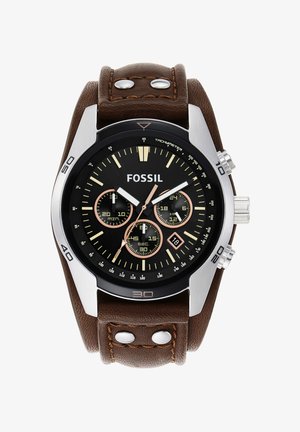 Orologio analogico con quadrante nero, benessere argento, cinturino in pelle marrone, quadranti cronografi e lancette luminescenti. Mostra la data alle 6.