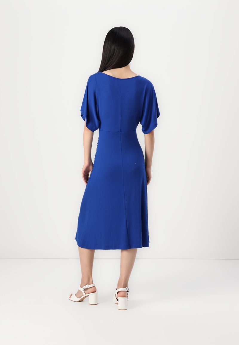 Blaues Midikleid mit kurzen, schwingenden Ärmeln, tailliertem Oberteil und ausgestellt rock. Glattes Material mit weicher Textur. In einfarbigem Design.