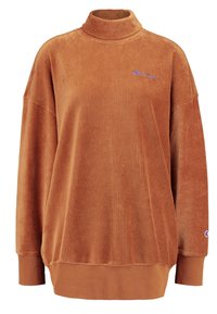 Sweatshirt en velours côtelé marron avec col haut, coupe oversize, texture côtelée et logo brodé sur la poitrine et la manche.