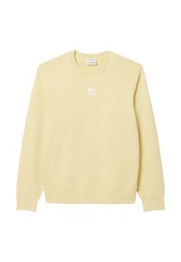 Sudadera amarilla hecha de tejido suave, con cuello redondo, mangas largas y un logo blanco de Lacoste en el pecho. Diseño simple y sin adornos.