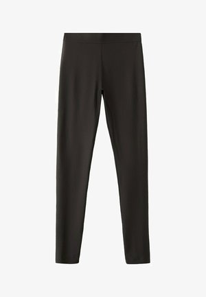 Leggings noirs slim avec une taille élastique, tissu lisse, sans ornements visibles ni poches.