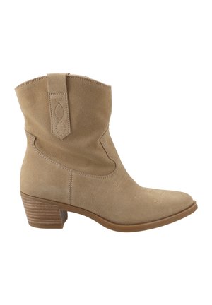 Suede ankle boots in tan with a rounded toe, curved top edge, and decorative stitching. Features a stacked heel and pull tab for easy wear.