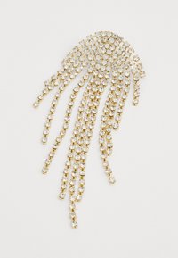 Golden brooch with cascading chain design, adorned with clear rhinestones. Features a curved top and multiple dangling strands.