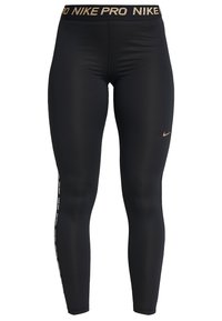 Czarne legginsy sportowe z elastycznego materiału. Posiadają złotą gumę w pasie z logo oraz białe napisy wzdłuż zewnętrznego szwu. Gładka tekstura.