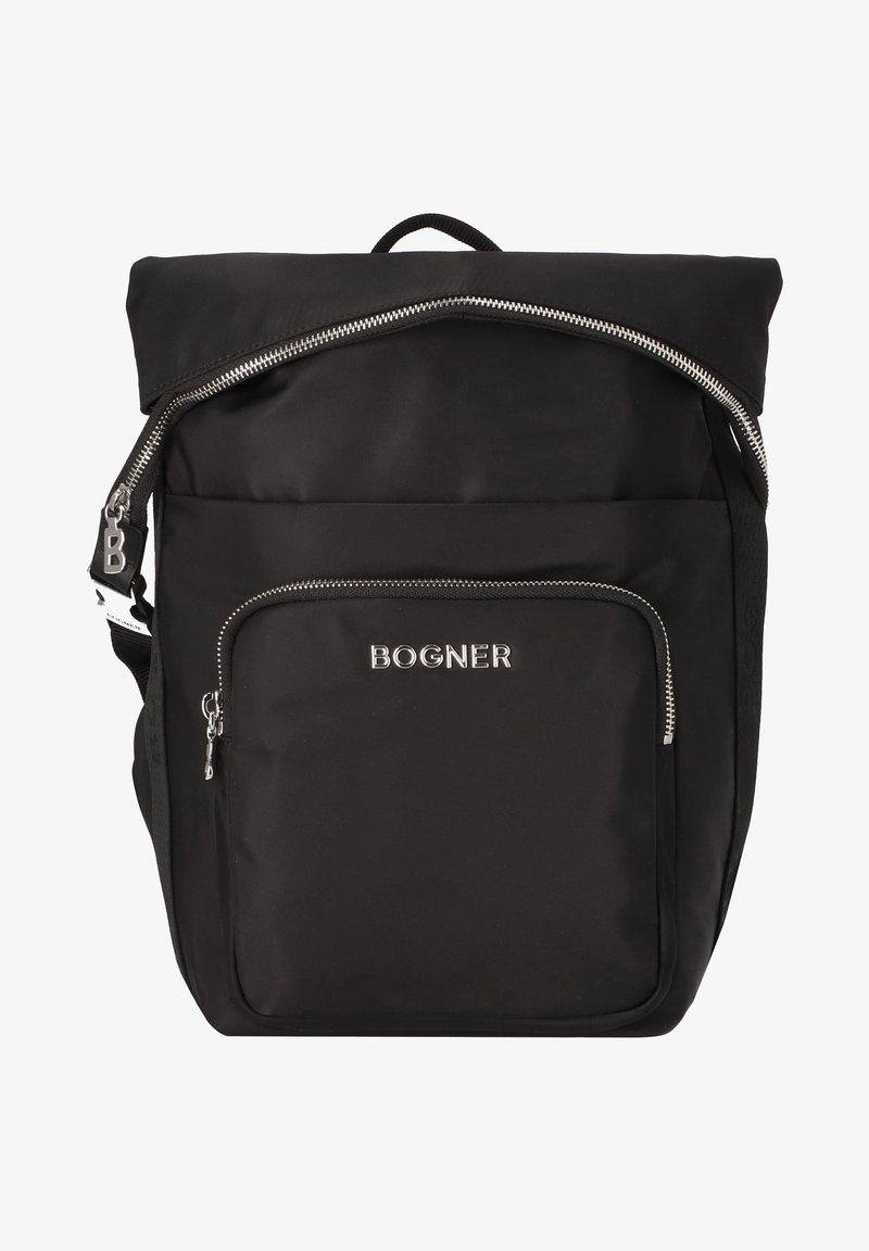 Mochila negra de nylon con cierre en la parte superior y bolsillo frontal, herrajes metálicos y un logotipo en la parte delantera. Diseño simple y estructurado.