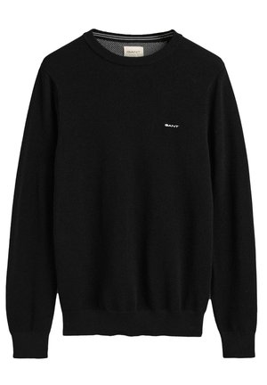 Sort strikket trøje med lange ærmer, rund hals, ribbede manchetter og kant, med et lille hvidt logo på brystet.