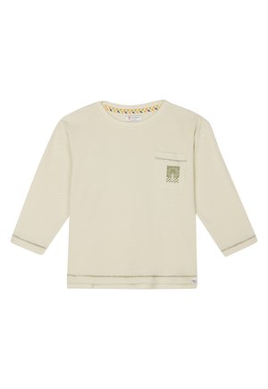 Langärmliges Creme-Oberteil aus weichem Stoff, mit einer Brusttasche mit grünem Palmenmotiv und bunten Streifen am Ausschnitt.