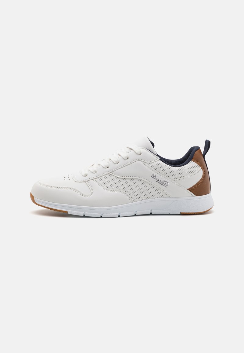 White athletic shoe with perforated leather panels, brown accents on the heel, rubber outsole, and white laces. Minimalist design, casual style.
