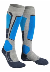 Calze al ginocchio con una base grigia e motivi geometrici blu e navy. Realizzate in materiale morbido con texture a costine e punta rinforzata.