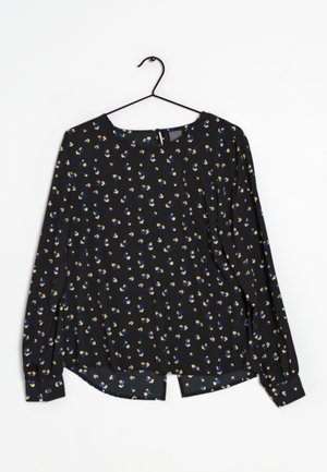 Schwarze Bluse mit langen Ärmeln und kleinem blauem, gelbem und weißem Blumenmuster. Runder Ausschnitt und leicht geschwungener Saum, aus leichtem Material gefertigt.