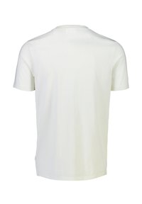 T-shirt bianco in cotone con maniche corte e scollo rotondo. Tessuto liscio, taglio dritto con orlo posteriore leggermente più lungo, senza motivi né loghi.