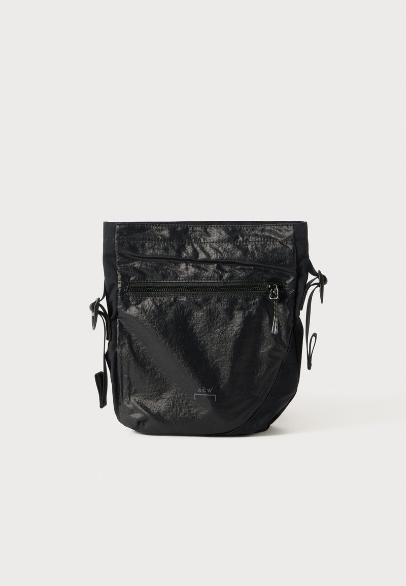 Black waterproof bag made of textured nylon, featuring a top zip closure, front zip pocket, and adjustable cord sides.