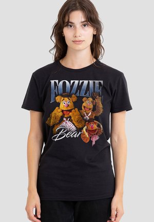 Young woman wearing black t-shirt with colorful Fozzie Bear characters from the Muppets and text "Fozzie Bear" on the front.