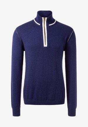 Pull bleu marine à manches longues avec une fermeture éclair devant sur la moitié, col montant et bordure blanche le long de la fermeture éclair et des coutures des épaules.