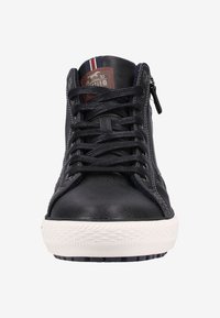 Baskets montantes en cuir noir avec un laçage à l'avant, une fermeture éclair sur le côté et une semelle en caoutchouc blanc. Comprend une étiquette de marque et un accent rayé au niveau du col.