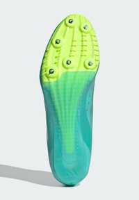 Firm, lightweight green and yellow athletic shoe bottom with six metal studs, textured surface, and a transparent upper section.