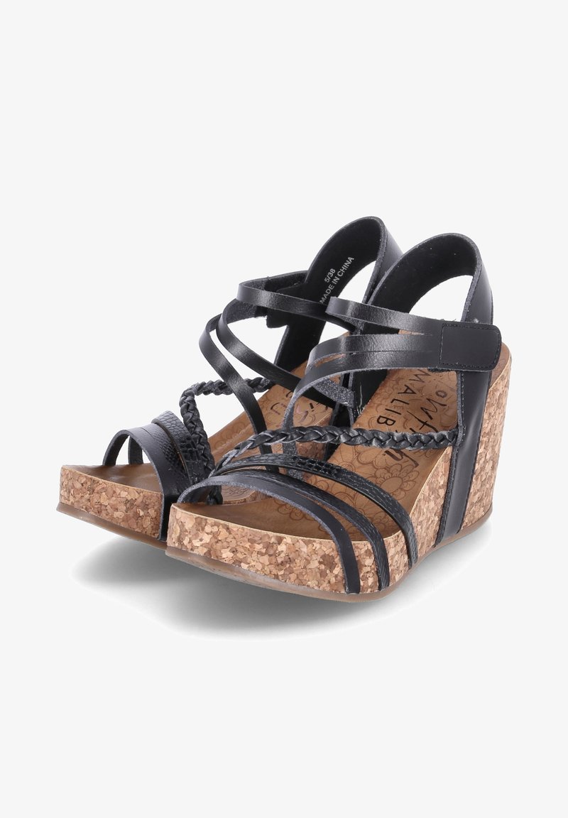Sandales compensées noires avec une plateforme en liège, des brides en cuir croisées et des accents tressés, dotées d'un design à bout ouvert et d'une semelle texturée.