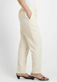Crème-kleurige, lichtgewicht broek met een elastische tailleband, zijzakken en een recht model, geschikt voor casual gebruik.