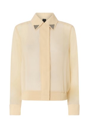 Camicia a maniche lunghe color crema con colletto appuntito arricchito da punte decorative in metallo triangolari argentate, patta frontale nascosta e fascia in vita aderente.