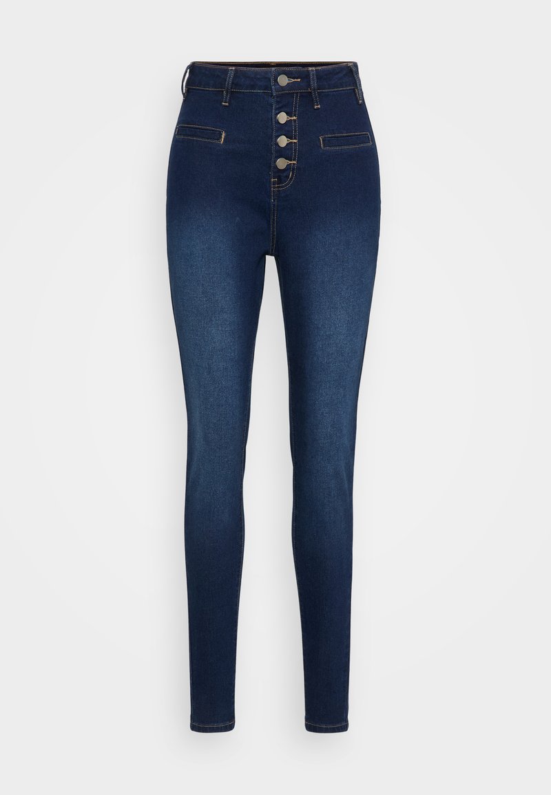 Jeans skinny de talle alto en azul oscuro, con cuatro botones frontales y dos bolsillos de ojal, exhibidos sobre un fondo blanco.