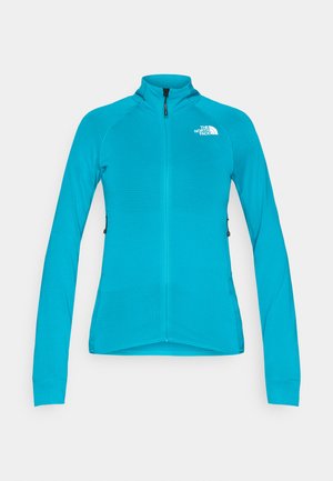 Türkisfarbene Reißverschlussjacke aus strukturiertem Stoff, mit hohem Kragen, langen Ärmeln und einem gestickten Logo auf der linken Brust.