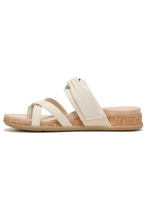 Beige sandal with cross straps and elasticated back, featuring a cork wedge sole and textured footbed, for comfort and support.
