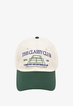 Beige cotton baseball cap with a green visor. Features embroidered text "THE CLASSY CLUB" and a tennis court graphic.