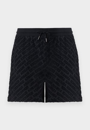 Zwarte terry shorts met elastische tailleband en trekkoord, voorzien van een herhaald reliëf "Armani Exchange" tekstpatroon.
