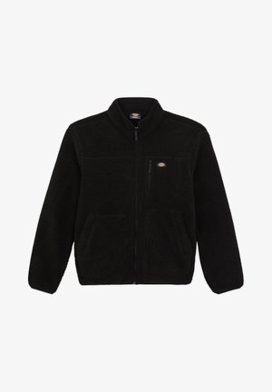 Chaqueta de forro polar negra con cierre en la parte delantera, cuello alto y dos bolsillos frontales tipo parche. Presenta un pequeño logo en la parte superior del lado izquierdo del pecho.