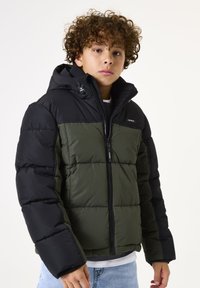 Doudoune avec capuche et manches noires, corps vert olive. Design texturé avec piquage, fermeture éclair à l'avant et détail de logo.