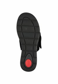 Zwarte schoenen zool met gestructureerd rubber, met een felrode gevoerde sectie gelabeld "Comfort" en maat "37" op de hak.