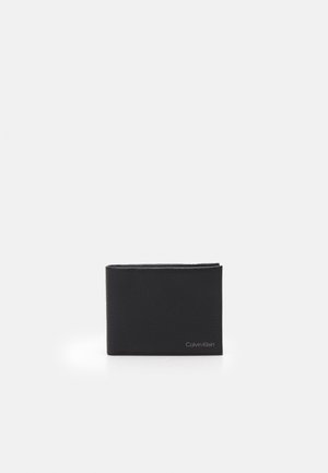 Black leather wallet with a textured finish, bi-fold design, and embossed Calvin Klein logo on the front. Compact and minimalistic shape.