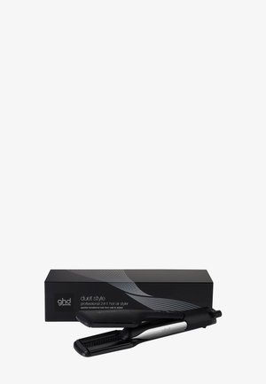 Schwarzes und silbernes ghd duet style 2-in-1 Glätteisen und Heißluftstyler mit schwarzer Verpackungsbox dahinter.