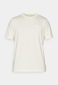 Tricou crem cu mânecă scurtă, fabricat din bumbac moale, cu guler rotund. Prezintă un mic logo brodat Puma pe piept.