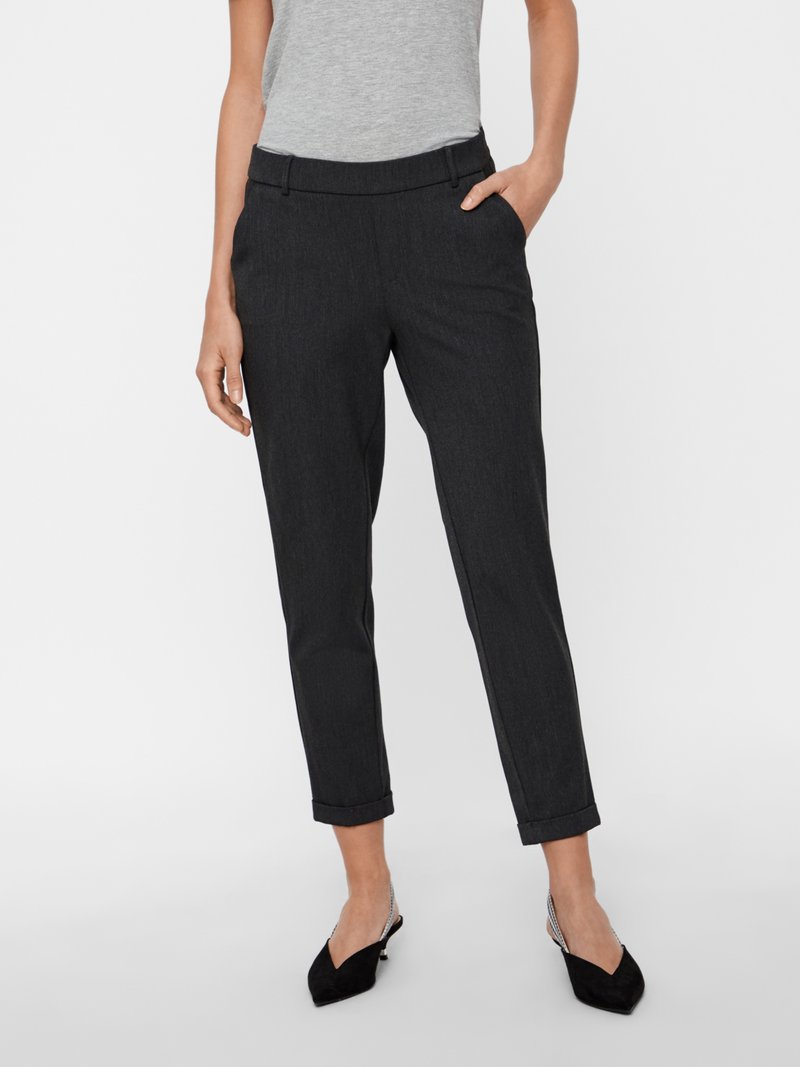 Dark gray tailored trousers with a tapered fit, creating a clean silhouette. Features front pockets and rolled cuffs. Worn with a gray top and black shoes.