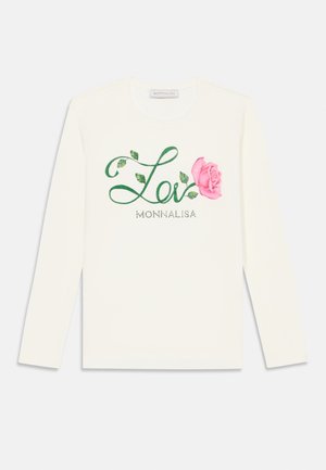 Camisa de algodón blanca de manga larga con texto verde en cursiva "Lé" y un diseño de rosa rosa, adornada con pequeños acentos de cristal.