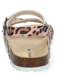 Leopard print sandals with a pink base, adjustable straps, brown cork footbed, and white outsole. Soft texture and flat design.
