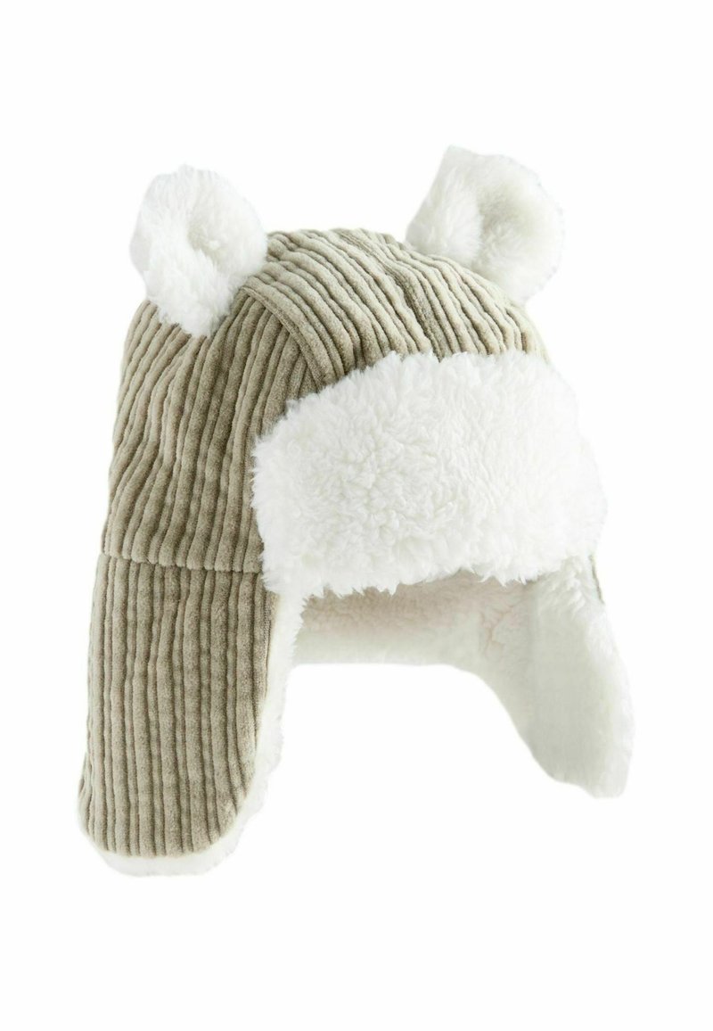 Chapeau en velours côtelé tan avec garniture en fausse fourrure blanche et accents en forme d'oreilles. Dispose d'un design à rabat pour la chaleur et un contraste de textures.
